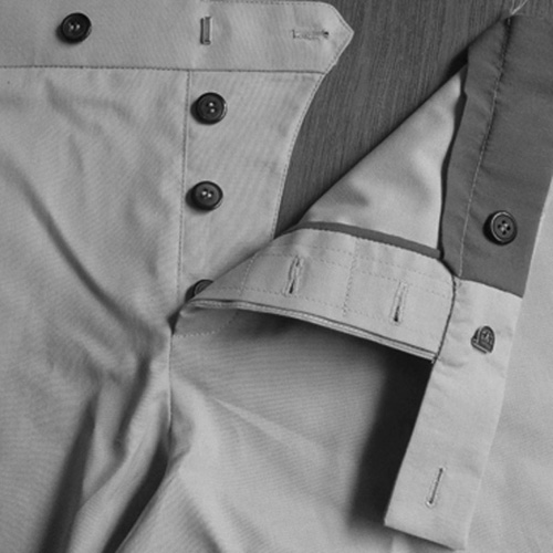 Button fly front closure in pants and trousers.