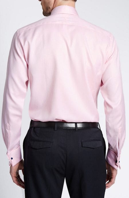 Back view of the men's pink oxford shirt, showcasing the clean lines of the one-piece shoulder yoke and the tailored fit through the torso.