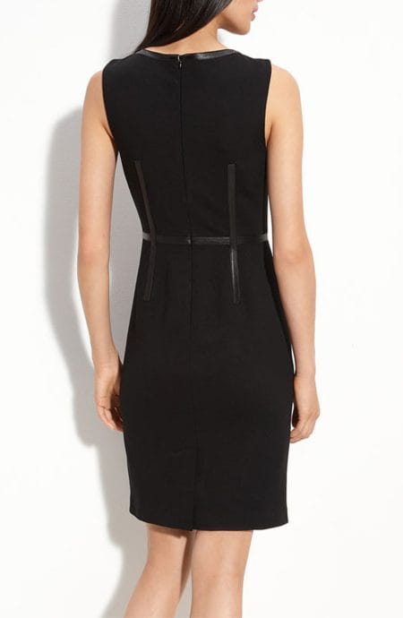 Black dress with leather trims in sleeveless cut with zipper back closure full back view.