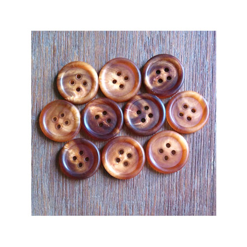 Hand made brown horn buttons for garments.