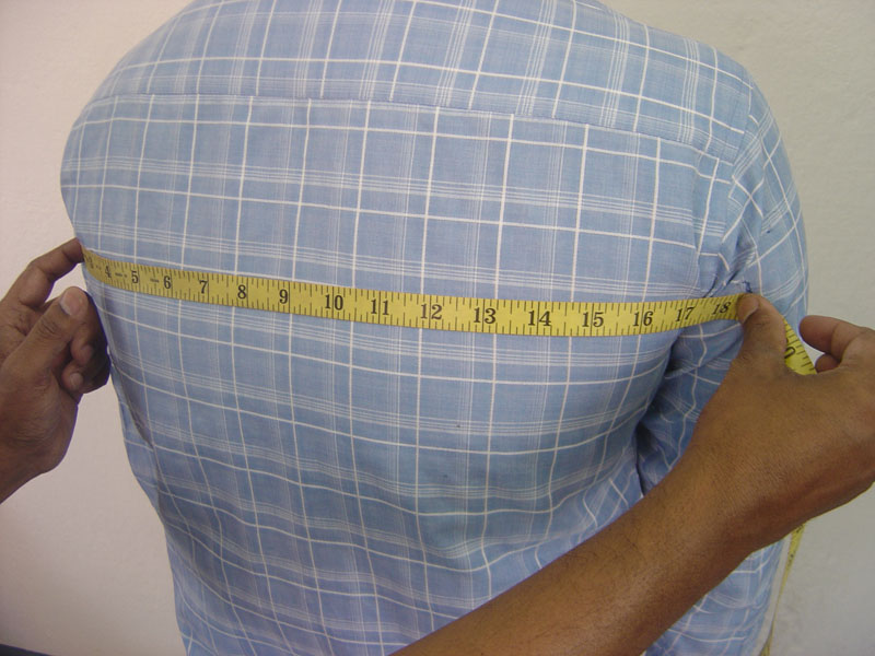 Measuring men's body back chest for the custom-made garments. A right view.