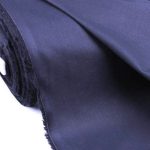 Lightweight navy blue cotton fabric for trims and piping in the custom-made garments.