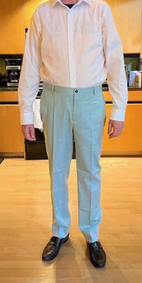 A customer wearing the test suit trousers for their Dupioni Silk Suit, confirming the fit and break as part of our flawless fit guarantee.