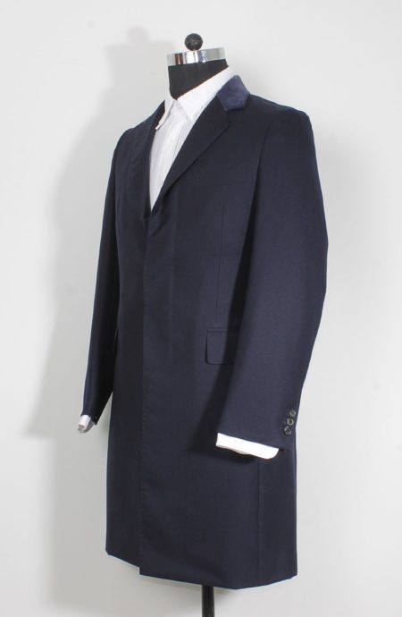 Womens navy coat replica from Spectre in Bond's style; a side profile view.
