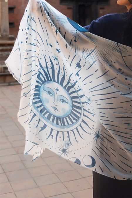 Close-up detail view of the sun print illustration and the handwoven texture of the Solar and Lunar Print Cashmere Loom Scarf.