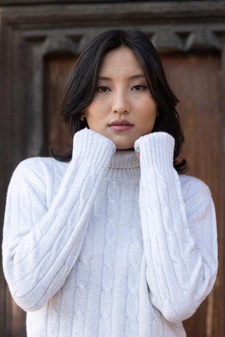 Close-up of a Baron Boutique Fog Cable Knit Cashmere Turtleneck Sweater highlighting the cable knit texture and turtleneck neckline.