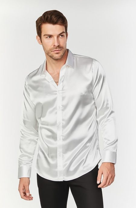 Elegant man with short brown hair and light stubble looking to the side, wearing a lustrous white satin silk long-sleeved shirt featuring a classic business collar, set against a clean white backdrop.