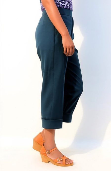 Side view of 13th Doctor Jodie Whittaker replica cropped pants. The teal mohair wool trousers show the 2-inch wide waistband, a straight leg profile, and functional side slant pockets. The cropped length falls just above the ankle, revealing the clean hem.