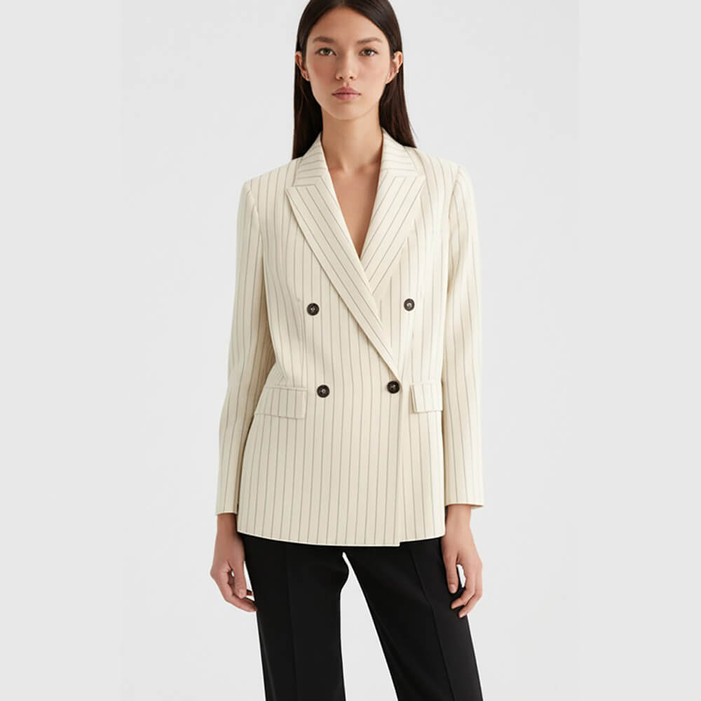 Front view of a female model wearing an off-white pinstripe double-breasted suit jacket styled as a versatile separate with black trousers. This elegant blazer is perfect for creating chic everyday outfits, smart casual looks, and transitional work-to-weekend ensembles.