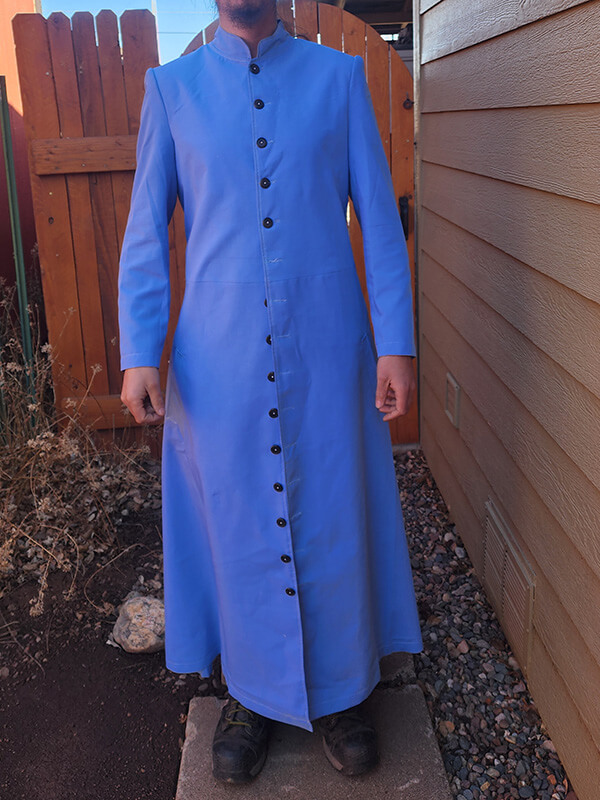 Front view of the blue test coat for the Neo Leather Trench Coat from the Matrix Reloaded. This test coat confirms the fit of the custom-made, genuine black leather trench coat before crafting. The image highlights the single-breasted design, Mandarin collar, and button details.