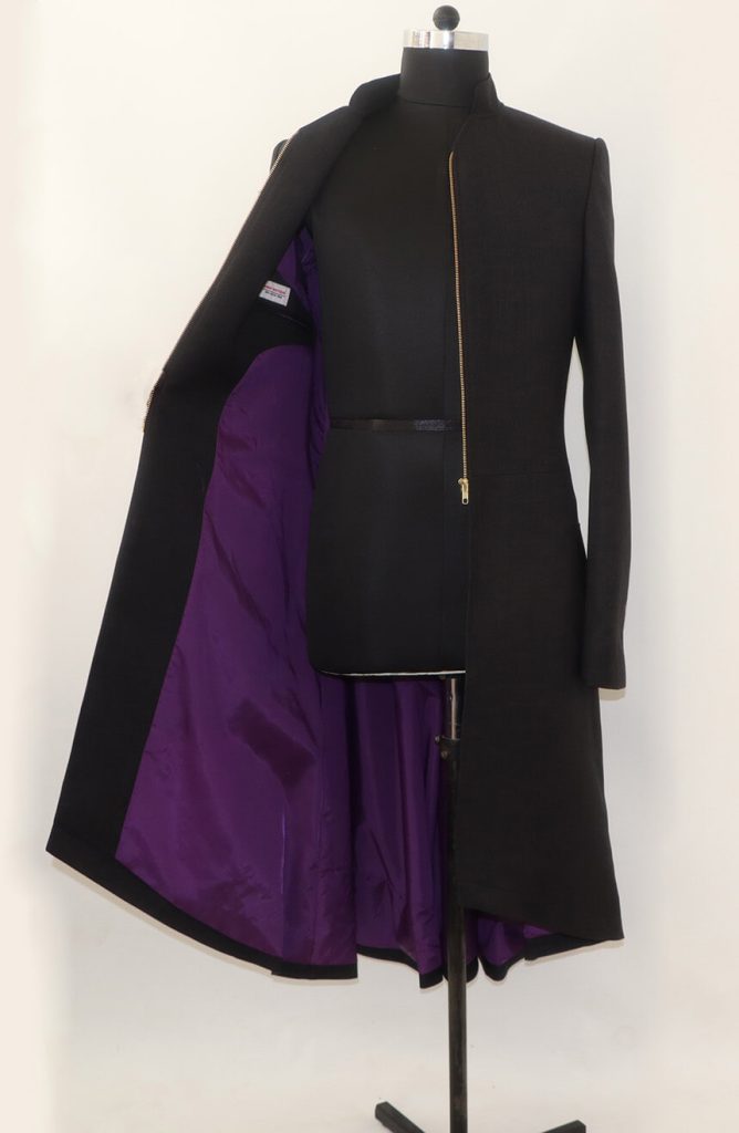 Men's black wool zip-up tailcoat opened to reveal the vibrant purple inner lining.