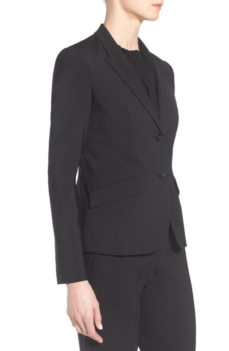 Side profile of The Performance Tropical Wool Pantsuit jacket, highlighting the contoured silhouette and tailored fit through the waist.