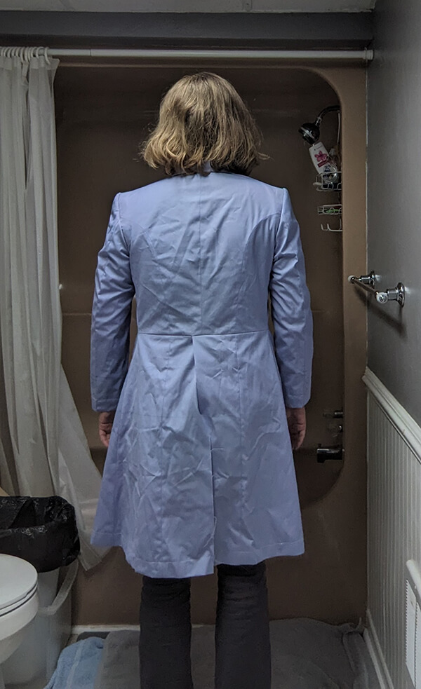 Customer modeling Baron Boutique’s Time Lord Test Frock Coat, full back view showcasing tailoring lines, coat length, and rear details during the fitting stage.