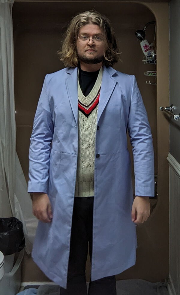 Customer trying on Baron Boutique’s Time Lord Test Frock Coat, front full view with buttons open, designed to confirm comfort, drape, and tailoring adjustments before crafting the final coat.