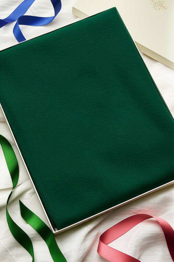 Emerald green cashmere shawl presented in an ivory gift box is a perfect bespoke cashmere gift for anniversaries, birthdays, holidays, or any special life events.