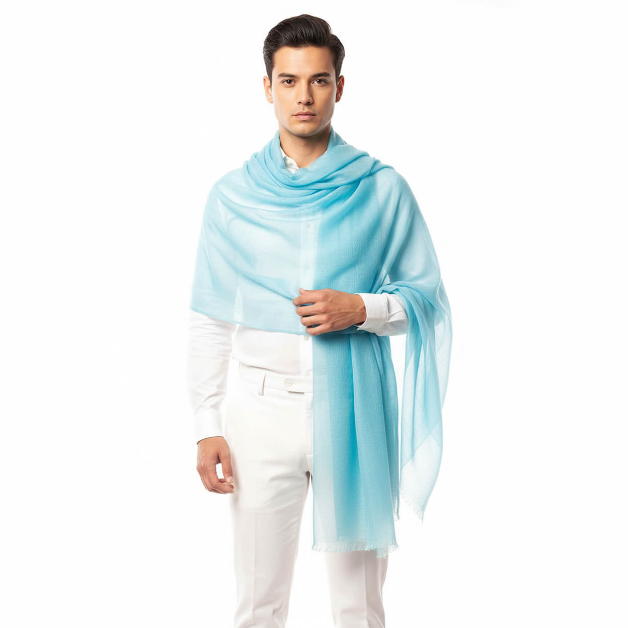 Man styling sky-blue 100% pashmina shawl with white suit—featuring handwoven Himalayan pashmina wrap showing artisanal craftsmanship, softness, and elegant drape.