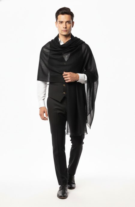 Formal men's black pashmina shawl wrapped as evening wear over tailored black vest and white dress shirt