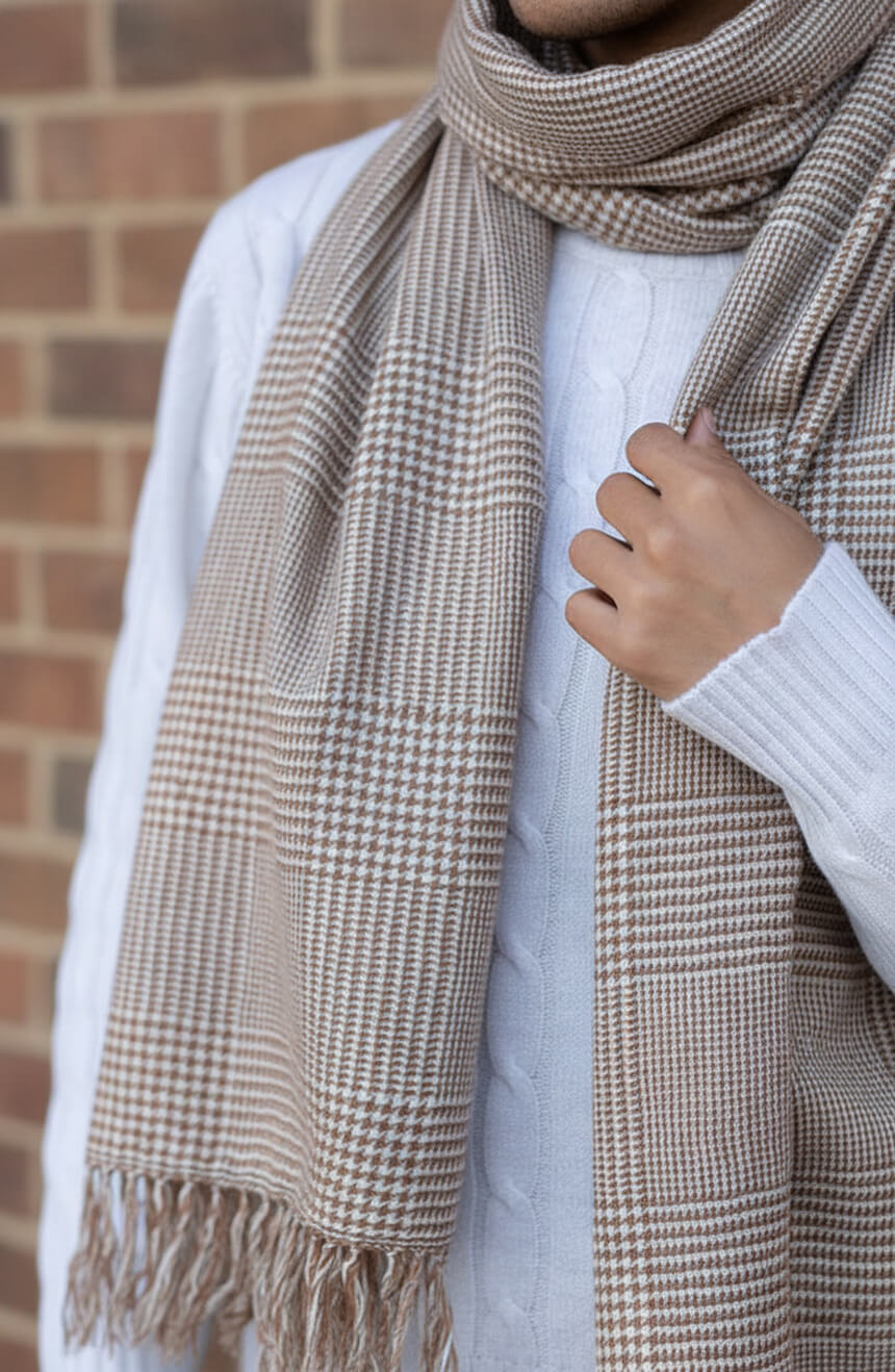 Close-up detail shot showing the fine Grade A cashmere houndstooth weave of the men's scarf, highlighting premium fiber quality and meticulous textile craftsmanship.