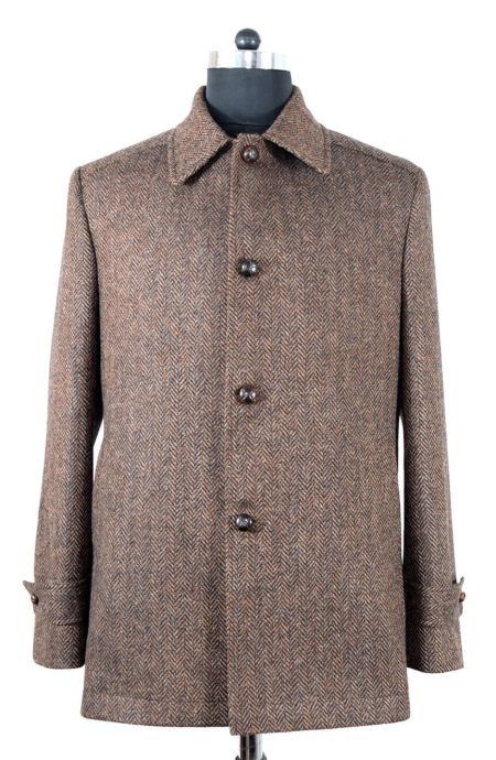 Front view of mens herringbone wool car coat in tweed with shirt-style collar, V-weaving, and football horn button fastening.