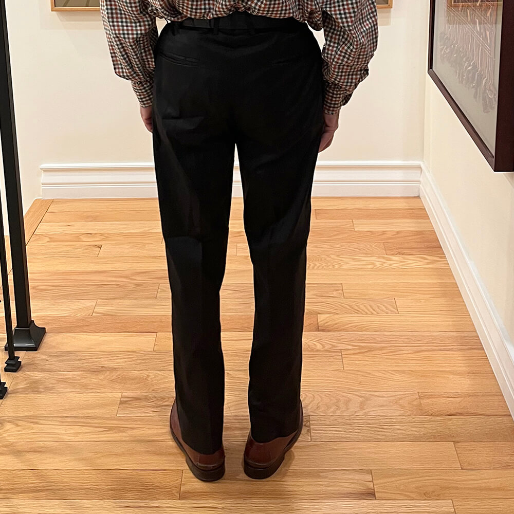 Men's custom dupioni silk trousers back view in black showing welt back pockets and tailored fit through seat and legs.