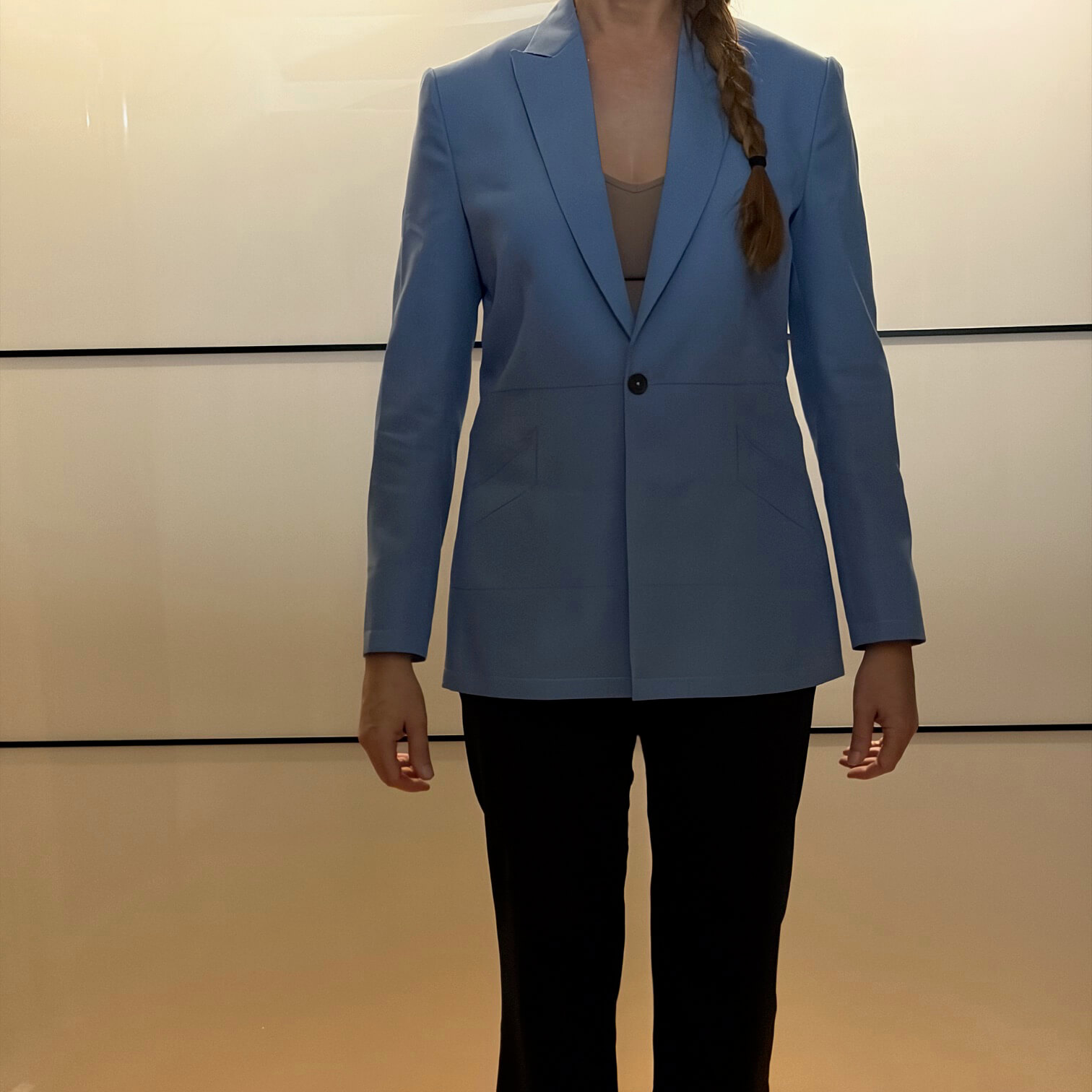Custom-fitted women's dupioni silk test jacket front view displaying inset peak lapels and single-button waist closure