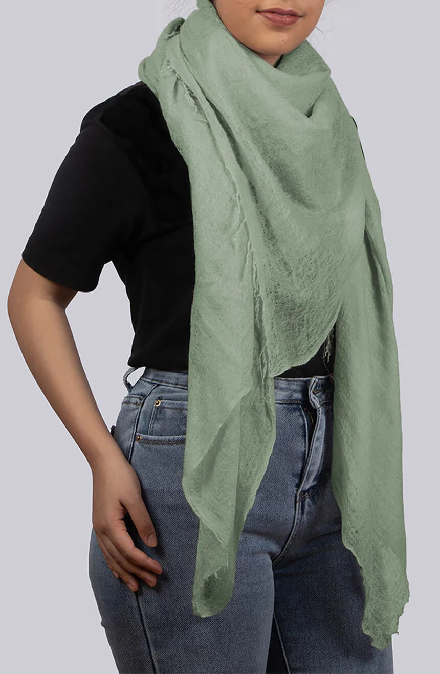 Handwoven willow green cashmere scarf shawl profile view.