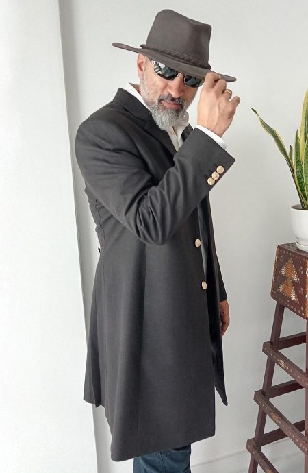 12th Doctor grey linen frock coat side profile view showing sleeve cuff gold buttons and ¾ length silhouette. The series 10 custom cosplay coat, Baron Boutique.