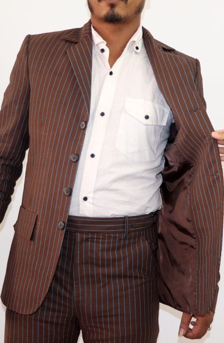 Interior view of the tenth Doctor brown and blue stripe suit, showcasing the lining, pic stitch details, and the breast pocket.