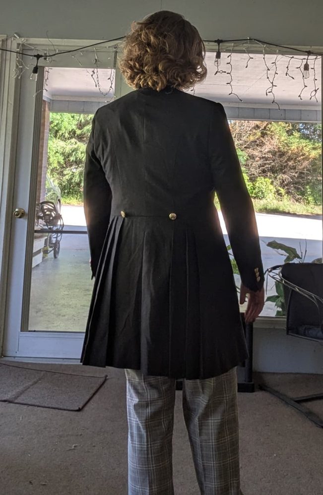 Customer wearing a custom-made 12th Doctor grey linen coat by Baron Boutique, showcasing the full back view and sleeves button.