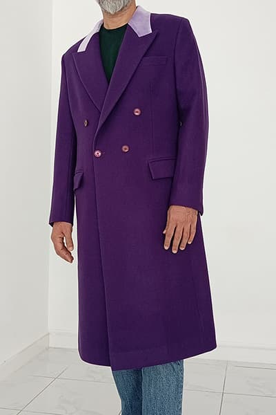 Happy customer wearing a custom-made 1989 Jack Nicholson Joker coat replica by Baron Boutique, featuring the iconic purple wool overcoat with contrasting lavender collar details and screen-inspired tailoring.