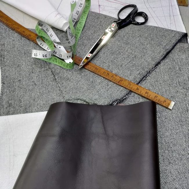 Herringbone tweed and tailoring shears on the cutting table