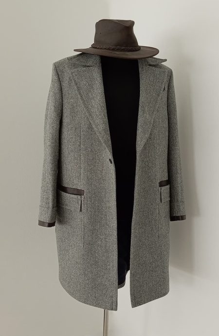 Front view of Newt inspired grey herringbone tweed coat with leather accents, tailored wizard-style overcoat crafted in British tweed for cosplay, fantasy fashion, and vintage enthusiasts.
