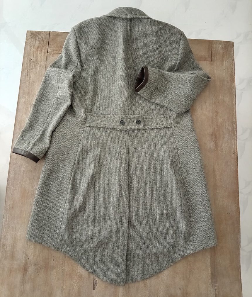 Lay-flat back view of handcrafted Newt-inspired herringbone tweed overcoat with adjustable back belt detail, showcasing premium British tweed craftsmanship and wizard-inspired design.