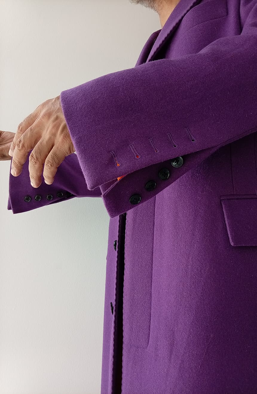 Close-up of the bell sleeve detail on a Heath Ledger Joker inspired purple coat from The Dark Knight displayed on a mannequin, featuring tailored cuff construction with 5 working buttons and dramatic vintage-inspired styling.
