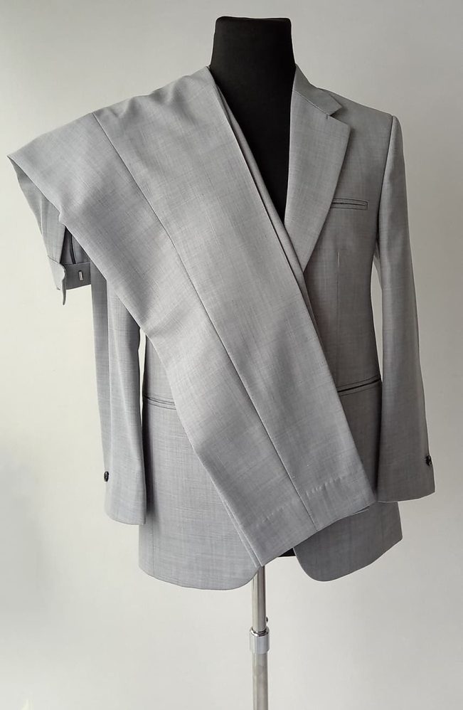 Men's Tom Cruise Collateral suit in light grey worsted wool on mannequin, jacket and trousers displayed together showing full suit construction, front view