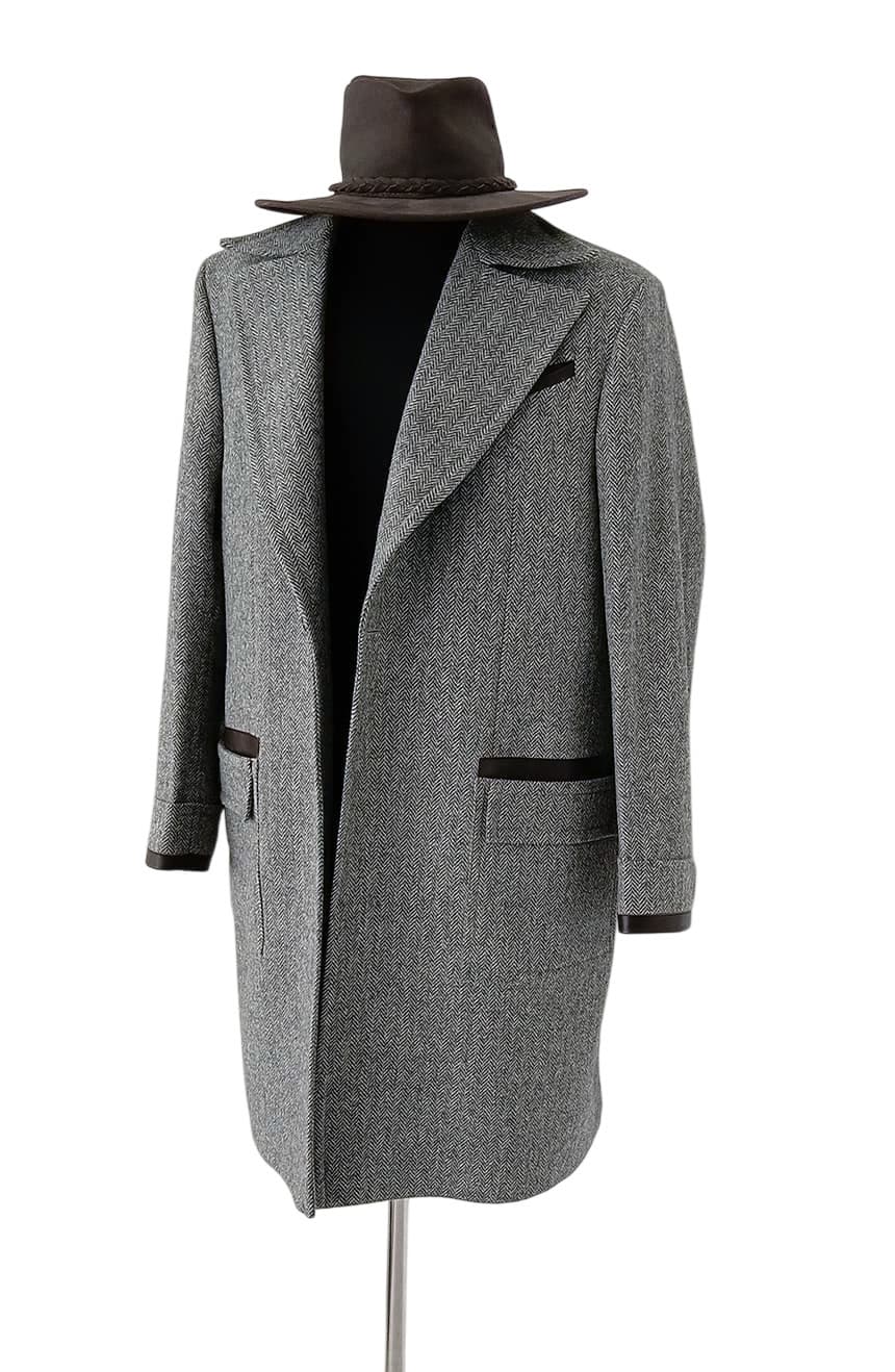 Elegant front angle of grey herringbone tweed Newt-inspired coat with premium leather pocket accents, designed for dark academia, cosplay, and fantasy-inspired wardrobes.