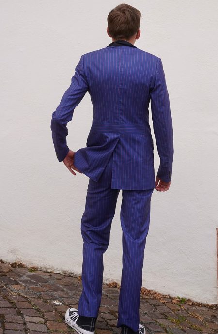 Tennant blue pinstripe suit rear full-length view showing the single back vent, tailored waist seam, and red stripe running down the jacket and straight-leg trousers.