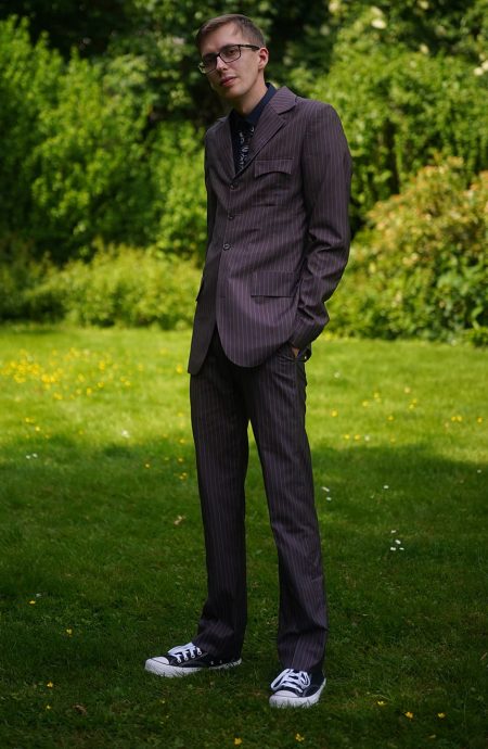 Front view of the Tennant brown and blue stripe suit, featuring a tailored fit, classic notch lapel, and single-breasted design worn with black shirt and Converse.