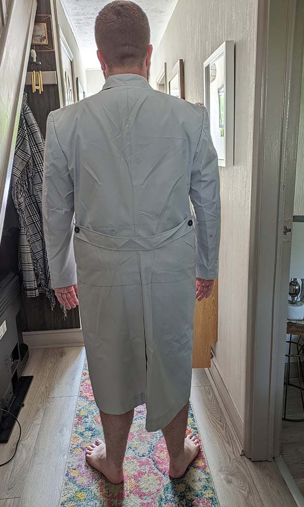 Back view of the 1989 vintage villain mock-up test garment displaying the single vent layout and waist belt positioning.