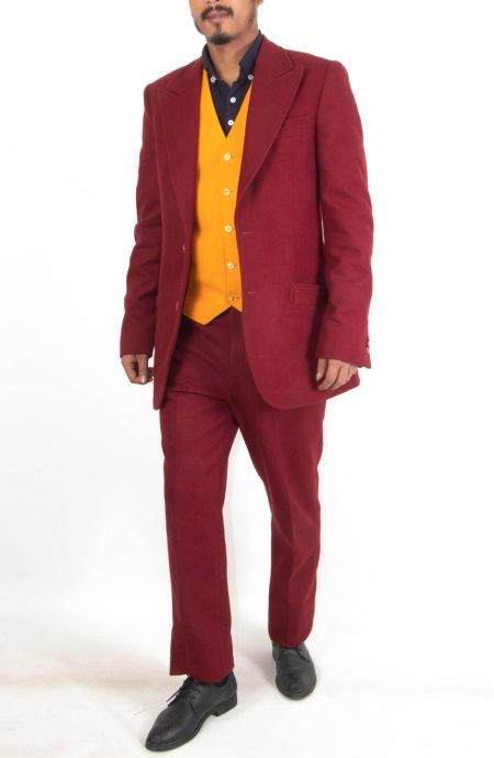 Bespoke 2019 burgundy suit reproduction displayed in a walking pose, showcasing the five-button gold yellow waistcoat, open front jacket construction, and matching trousers.