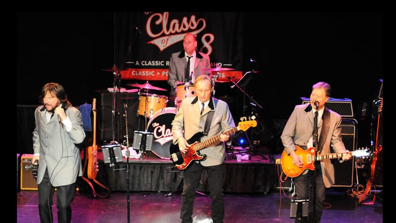 Four members of Class of 89 musical band performing wearing mod jackets tailored by Baron Boutique.