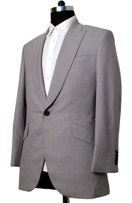 Grey sharkskin single-button suit jacket, side view featuring chest welt pocket, and slanted waist pockets.