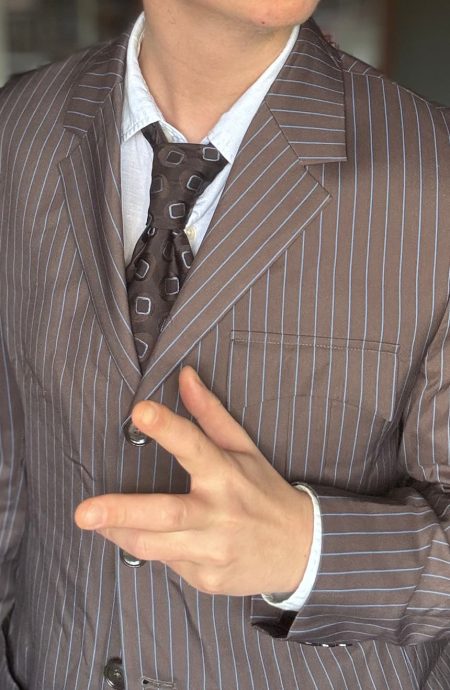 Front view of the women's 10th Doctor brown with blue pinstripe suit jacket, detailing the four-button front, notch lapels, and unique pocket configuration.