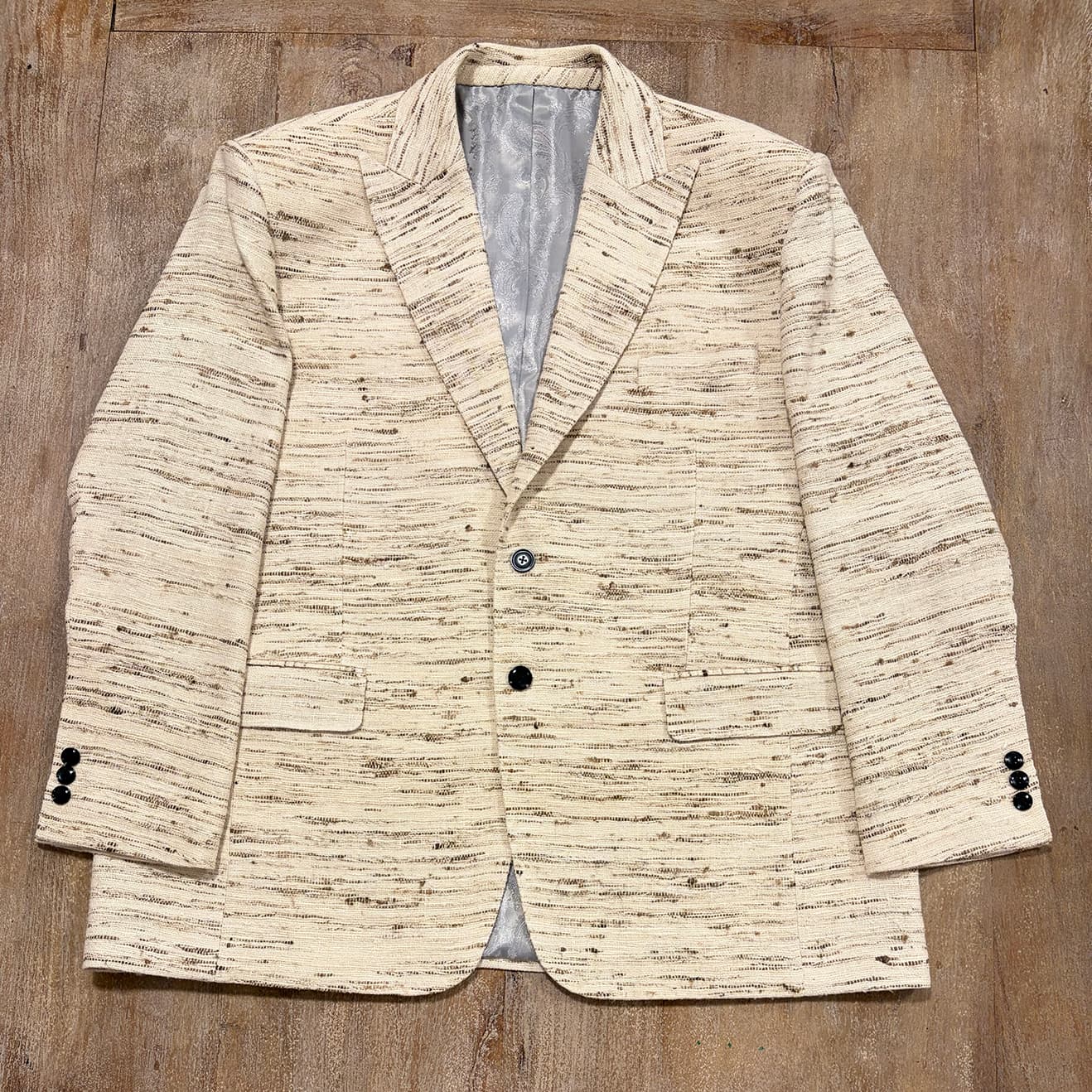 Men's raw silk blazer in unprocessed natural raw silk, full front view, three-roll-two button stance, peak lapel, flap hip pockets